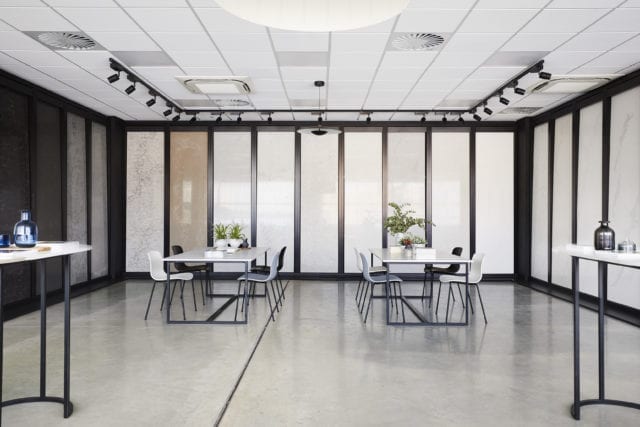 room with chairs and tables with plants on top