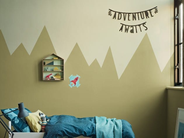 child’s bedroom with bed, toys and patterned wall