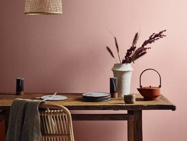 table and chair with plates, flowers and pendant light