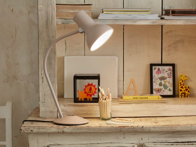 white anglepoise lamp in front of dresser shelves