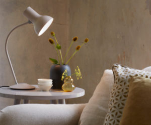 white anglepoise lamp on table next to sofa