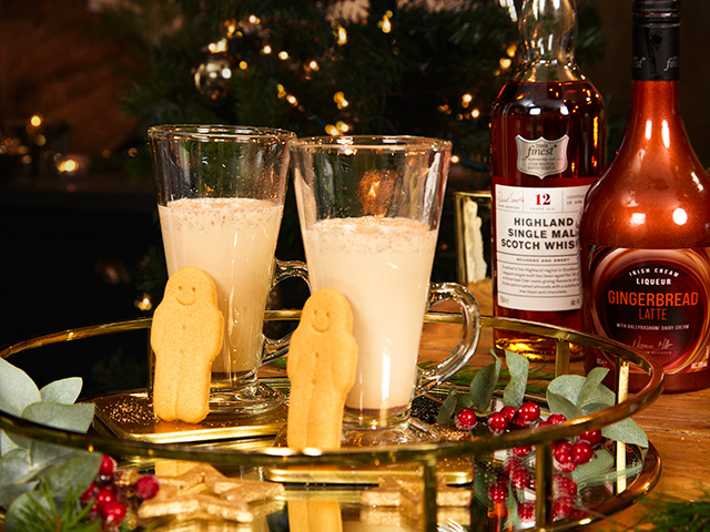 Gingerbread latte liqueur served in a latte glass, with mini gingerbread men - christmas cocktail recipes - goodhomesmagazine.com