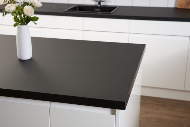kitchen cabinets with white cupboards and black worksurface