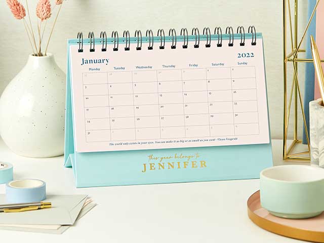 Desk calendar on desk with vase, mug and washi tape