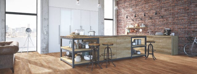 modern kitchen with island, stools, brick wall and city views