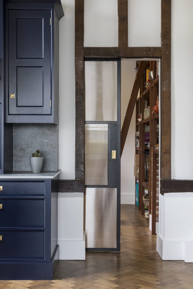 sliding black screen door between kitchen and hallway