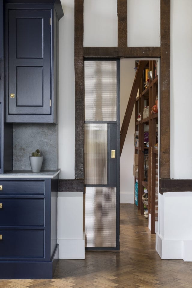 sliding black screen door between kitchen and hallway