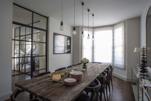 large dining table and chairs, pendant lighting, bay window and crittall-style doors