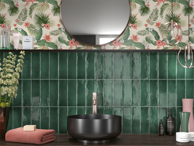 green metro bathroom tiles used as a splashback with patterned wallpaper on the top half of the wall