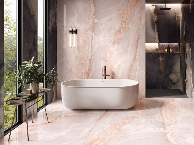 large-format onyx tiles used all over bathroom floors and walls with large freestanding tub and walk-in shower area