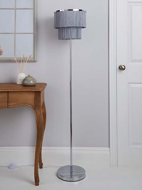 Dunelm fringe floor lamp next to oak wooden side table, goodhomesmagazine.com