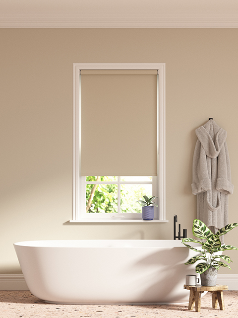 Greige bathroom with roller blind and freestanding bath