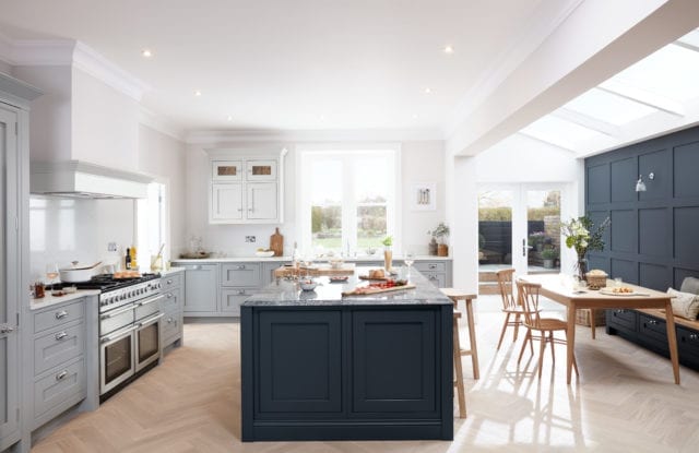 bright kitchen with navy and silver panelling and an island