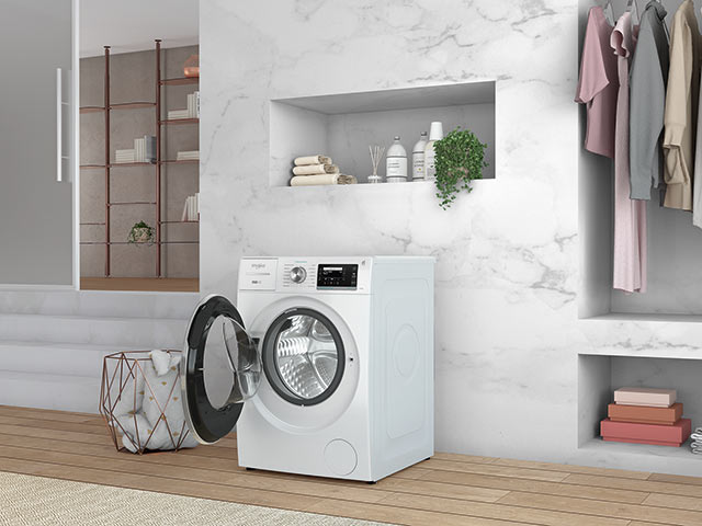 Washing machine against marble wall with door open