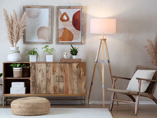 tripod floor lamp with white/beige lampshade in a scandi-chic home