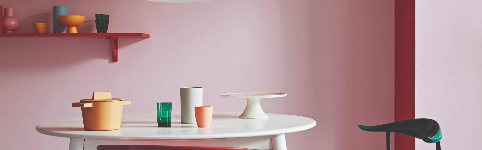 chairs and seats in different colours, in front of red and pink wall