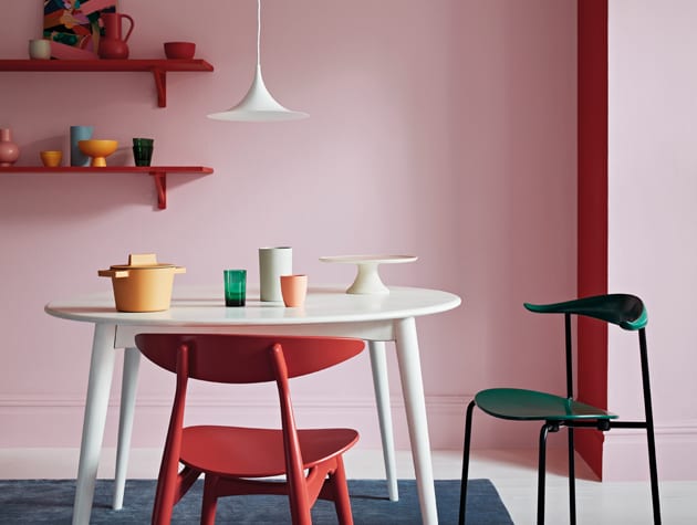 chairs and seats in different colours, in front of red and pink wall