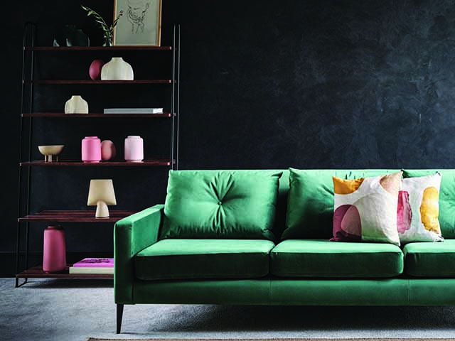 Green sofa with pink vases on wooden shelves, goodhomesmagazine.com