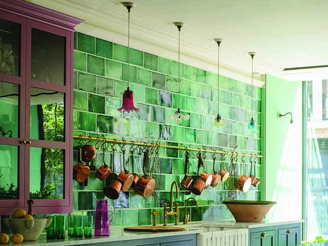Pink and green styled kitchen with green tiles and copper saucepans, goodhomesmagazine.com