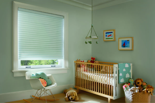 contemporary nursery with wooden cot, toys and modern rocking chair with Sonnette™ window shades