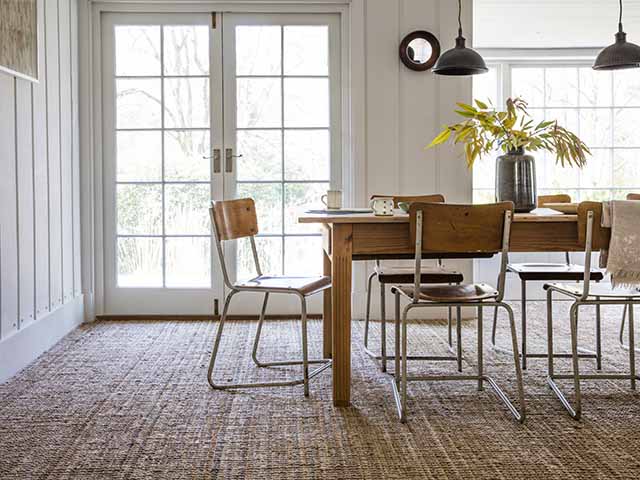 Jutle boucle flooring in dining room with double clear doors, goodhomesmagazine.com