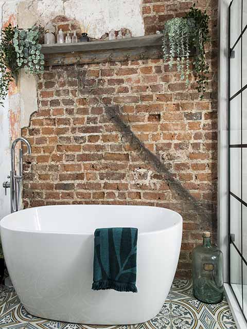 Exposed brickwork with freestanding bath tub, goodhomesmagazine.com