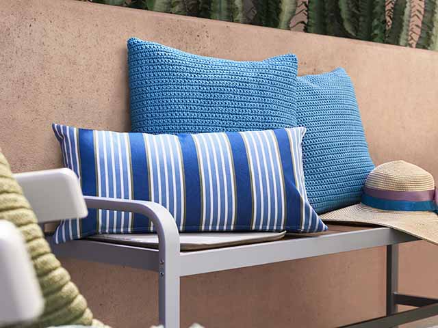 Blue crocheted cushions on outdoor seating, goodhomesmagazine.com 