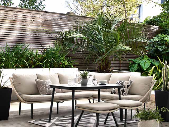 Garden furniture against greenery and fence, goodhomesmagazine.com