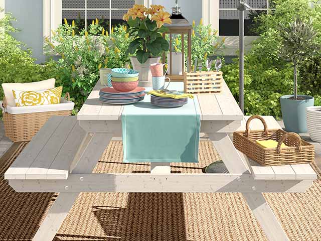 Decorated picnic table on decking, goodhomesmagazine.com