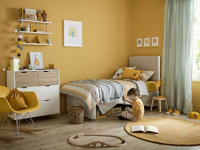 Silent Night bright yellow bedroom with children;'s bed, shelving and rugs, goodhomesmagazine.com