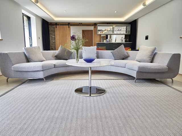 Herringbone natural carpet in lounge with floor lamp, goodhomesmagazine.com