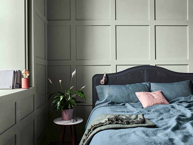 Panelled green wall with double bed spread, goodhomesmagazine.com