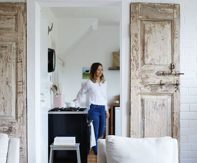 Rustic, reclaimed doors bought in India frame the entrance to the cottage’s kitchen