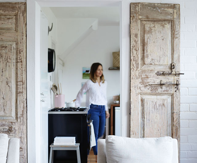 Rustic, reclaimed doors bought in India frame the entrance to the cottage’s kitchen 