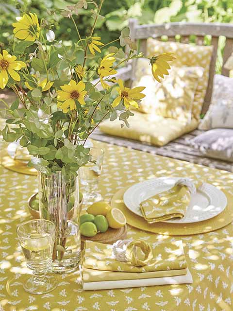 Yellow tablecloth and flowers for al-fresco afternoon tea, goodhomesmagazine.com