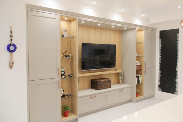 cabinet and shelving unit in kitchen with wall-mounted television