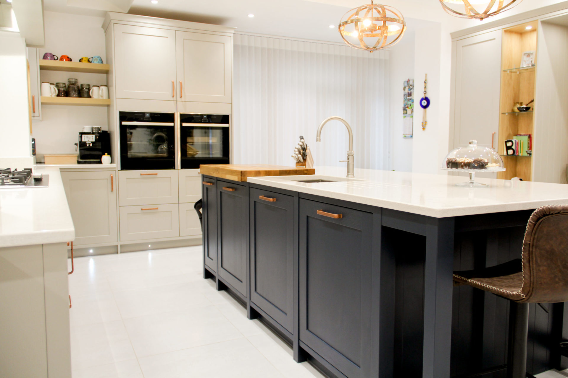 modern shaker kitchen in cream with island in dark blue