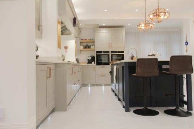 shaker-style kitchen with island, seats and pendant lighting