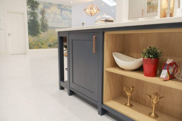 detail of kitchen island with cabinet door and shelves