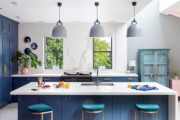 kitchen island with three blue chairs, pendant lighting and breakfast
