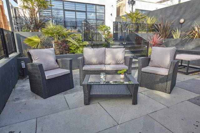 Split level patio with Furniture Maxi Rosen 4 seater rattan garden furniture set in black