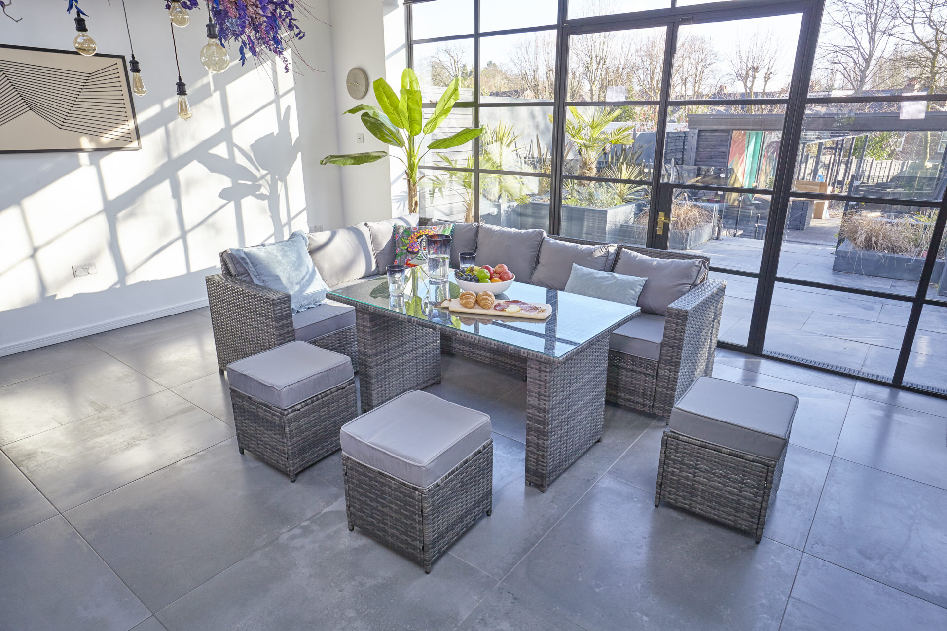 Modern room with steel frame windows and Furniture Maxi Barcelona rattan furniture dining set in grey