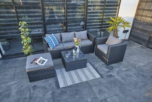 Modern paved patio and Furniture Maxi grey rattan furniture set with 3 seater sofa, armchair, stool and glass-top coffee table