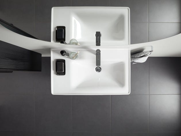 aerial view of white bathroom sink and reflection in mirror