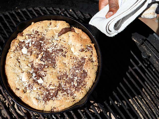 Hot cookie in a cast iron dish on a barbecue - Barbecue recipes - Goodhomesmagazine.com