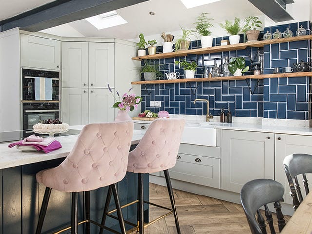 teal kitchen tiles with white cabinets and blush pink breakfast bar chairs