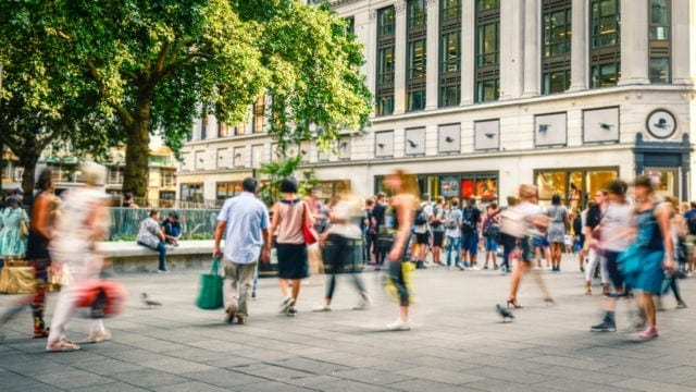 Delayed shutter image of people walking in a high street