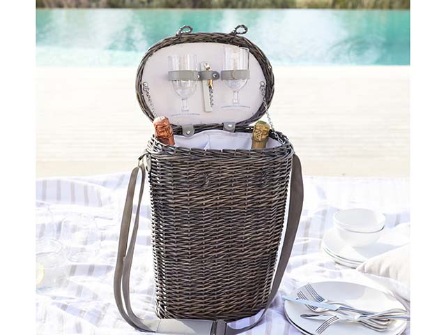 Basket on picnic blanket with champagne and glasses enclosed - goodhomesmagazine.com