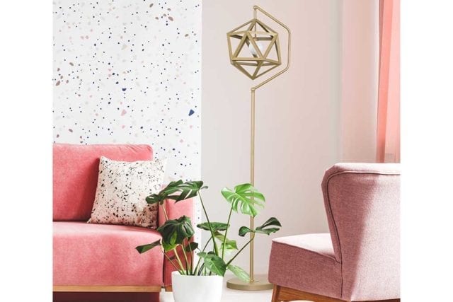 Gold cubic shaped floor lamp in a room with two pink armchairs - Rental decor - Goodhomesmagazine.com