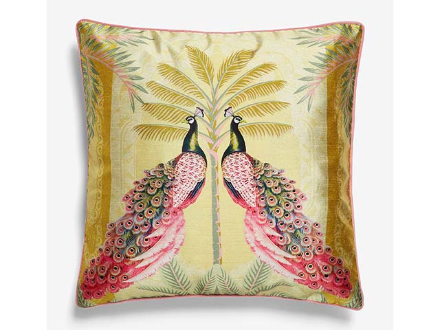 Gold cushion with pair of pink peacocks on front, goodhomesmagazine.com